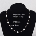 Elegant gold titanium steel pearl necklace with dimensions 40+5cm shown on display - Baroque Pearl Necklace (6x10mm)