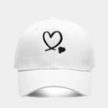 Close-up of white cotton baseball cap with black heart embroidery and detailed stitching - Adjustable / White