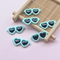 Close-up of mint green resin heart sunglasses charms for DIY craft and phone case decor - 28*12mm / Blue