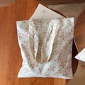 Close-up of a floral canvas tote bag showing the interior brand label and stitching detail - Colorful Floral Bow