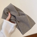 Detail of a brown wool-like knotted headband showing soft texture and twisted design - Oatmeal