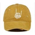 Detail of white skeleton hand embroidery on a distressed ginger cotton baseball cap - Orange
