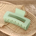 Detail of mint green matte rectangle hair claw clip on vintage newsprint in a basket - 8.5cm Cyan Green