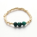 Detailed macro view of handmade ring with gold metal spacers and faceted green stones - Gold Dark Green