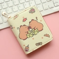 Detailed view of beige Capybara zipper wallet with cute cartoon bears on a pink desk - Face to Face Capybaras