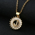 Macro detail of golden letter J pendant with baguette-cut cubic zirconia stones - Gold Letter J