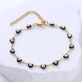 Gold stainless steel bracelet featuring black heart-shaped evil eye charms for women - Black Eye