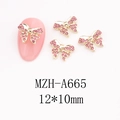 Detailed view of pink rhinestone bow nail art charms with gold alloy base and 12x10mm size - Large Bowknot (A665)