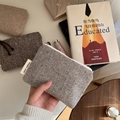 Detail of herringbone tweed mini coin purse with colorful dots and a white zipper - Light Gray
