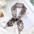 Detail of the letter Q silk scarf with moon and star prints on a soft white background - Sketch Spring Letter Q