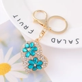 Macro shot of heart keychain with blue crystal flowers and white rhinestones - White Rhinestone Blue Flower Heart