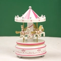 Pink and white carousel music box featuring golden pillars and unicorn details on a pedestal - Floral Pink