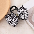 Chic black hair claw clip featuring a leopard print fabric bow and gold thread accents - Polka Dot Bow Hair Claw - White