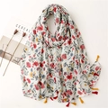 Floral voile scarf with red flowers and colorful tassels displayed on minimalist background - Red Yellow Blue Floral