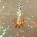 Orange crystal sunflower suncatcher with colorful beads creating rainbow light spots - Single Flower Champagne