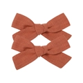 Set of two rust red linen bow hair clips with textured fabric on a white background - Bow Hair Clips Set / Rust Red
