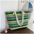 Detail of green canvas tote bag featuring ethnic geometric patterns and rope handles - Green Geometric Floral