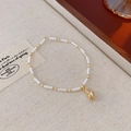 Detail of bohemian cream seed bead necklace with gold accents on linen background - Bracelet-White-Conch
