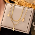 Detail of gold titanium double necklace with snake chain and blue evil eye charms - H1141 Necklace Gold