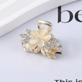 Macro detail of floral hair claw clip with white cat-eye petals and sparkly rhinestones - 8# Rhinestone Flower Claw Clip