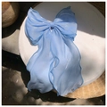 Close-up of sky blue oversized bow hair clip with shimmering tulle and fine sparkles - Large Bow with Long Streamers / Blue