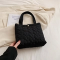 Chic black quilted tote bag with heart patterns and gold buckle detail - Black