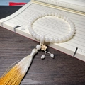 White Bodhi seed bracelet featuring a handmade long tassel and golden flower charm - Hand-held White Jade Bodhi (Plum Blossom Ring)