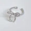 Silver bow knot ring with shimmering zircons in a minimalist open design style - Silver Plated White Zirconia Bow Open Ring (B565)