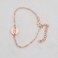 Rose gold chain bracelet featuring a round pendant with a hollowed-out letter H design - Rose Gold H