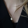 Elegant silver bow necklace with pearl pendant on a model in a black V-neck dress - Minimalist Pearl Pendant (XL1629)