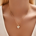 Elegant gold heart pendant necklace with white and green shell inlay on a female model - KN0463-2-Heart Green Gem Mother Of Pearl
