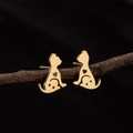 Minimalist gold cat stud earrings with heart cutouts displayed on a natural branch - Gold