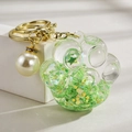 Cat paw acrylic keychain with green quicksand and golden star sequins in clear resin - Luminous Pearl Paw Style / Green