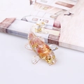 Resin koi fish figurine with pink petals and gold leaf inlay on a book - Watermelon Quartz
