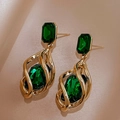 Detail view of emerald green gemstone set in a vintage gold-tone twisted hollow frame - Emerald Green Rhinestone (925 Silver Pin)