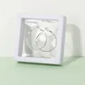 Silver hoop earrings displayed in a white square PE membrane floating storage box - 7x7x2cm / White
