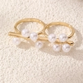 Detailed close-up of a double-band gold ring with eight elegant white pearls on stone - Double Finger Pearl Ring (RZ0872-C)