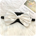 Silk sleep eye mask with cream satin bow and elastic strap on a soft white background - Black and White