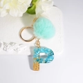 Blue resin letter P keychain with green faux fur pompom and gold-plated ring - Letter P