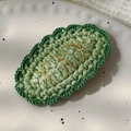 Detailed macro view of a green hand-knitted hair clip with elegant white pearl accents - 26228A Oval Green Pearl BB Hair Clip