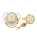 Close-up of golden rhinestone pacifier and clip set with letter K on white background - Letter K