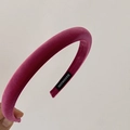 Detail shot of a thick rose red velvet padded headband featuring a handmade inner label - Raspberry Pink