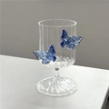 Elegant champagne glass with two 3D blue butterfly decorations on the crystal clear bowl - Striped / Blue