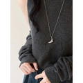 Nahaufnahme des Mondanhängers an einer langen silbernen Kette auf dunklem Strickpullover - Silber