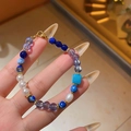 Detailed close-up of a blue zircon crystal beaded bracelet with white pearl accents - Bracelet-Blue