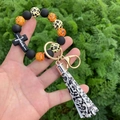 Detail of leopard print beads wristlet keychain with black cross and fringe tassel charm - Colorful Leopard