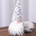 Christmas gnome plush doll with a grey knitted hat and white beard on a wooden table - Grey Plush