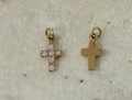 Front and back detail of a gold cross pendant with pink gemstones on stone background - Gold with Pink Opal