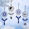 Blue Evil Eye and Om metal wind chime ornaments hanging against a clear sky background - 2004 (Bagua Evil Eye Om Eye)