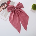 Close-up of rose pink satin bow hair clip with long ribbons on white background - Pink